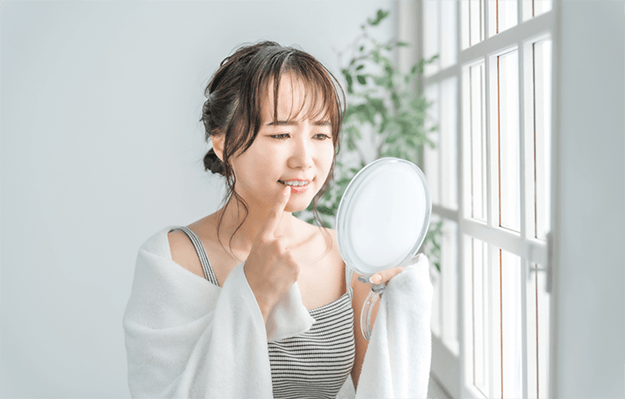 Patient in Shelbyville checking dental implant in the mirror