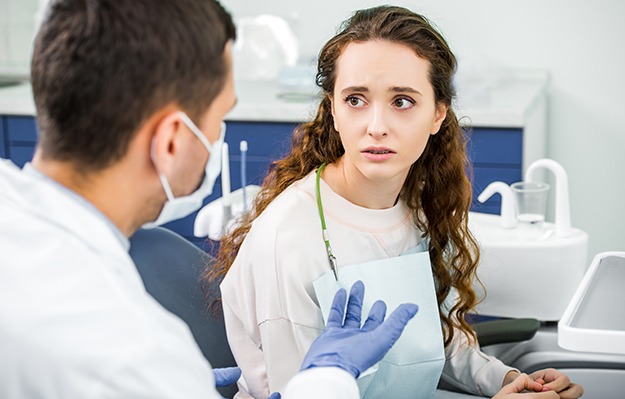 Patient in Shelbyville talking to dentist about dental implant salvage