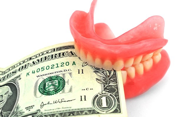 dentures with money between the teeth