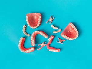 partial and full dentures with a blue background