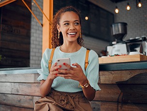 Smiling woman sitting on barstool at restaurant