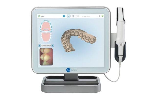 Computer screen showing close up photo and digital model of teeth