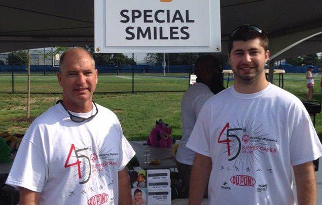 Dentist and team member at community event