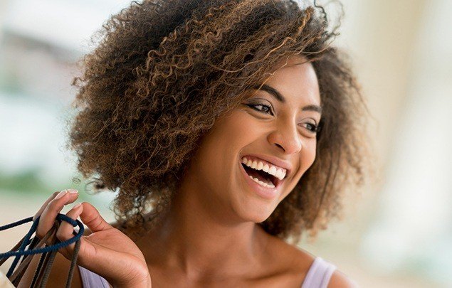 Woman smiling and holding several bags