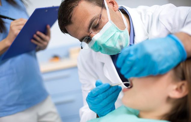 A dentist in Selbyville examining a patient