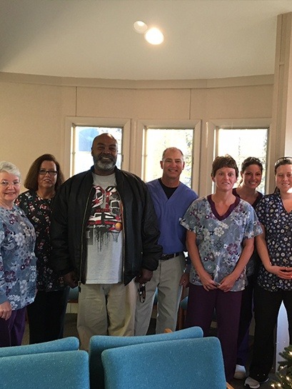 Dental team standing in large entrance room at community event