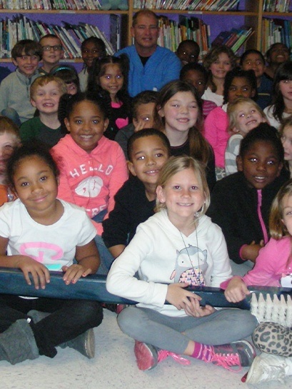 Group of kids holding oversized toothbrush