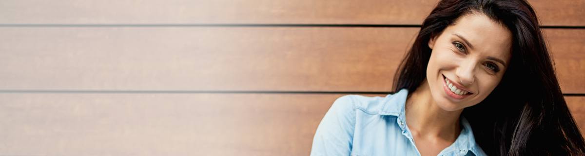 Woman with long brown hair smiling after cosmetic dentistry in Selbyville