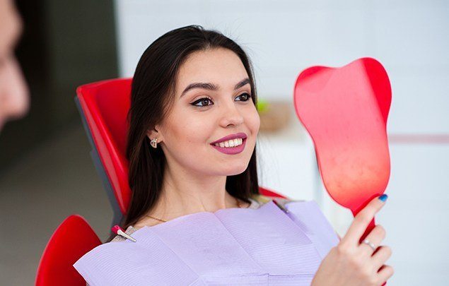 Woman looking at smile in mirror