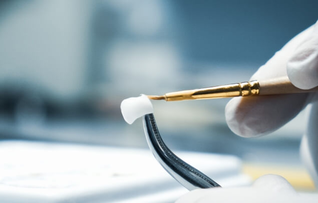 Dental ceramist designing a dental crown