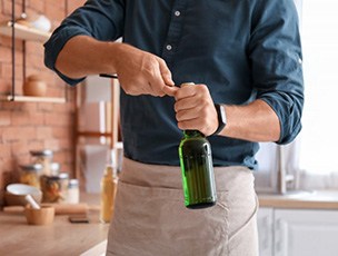 Man opens bottle with opener?