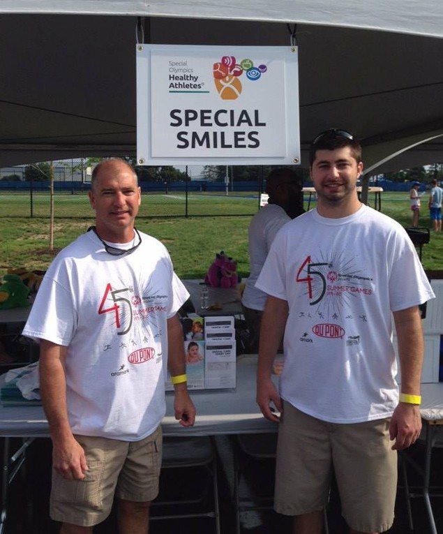 Dentist and team member at community event in Selbyville