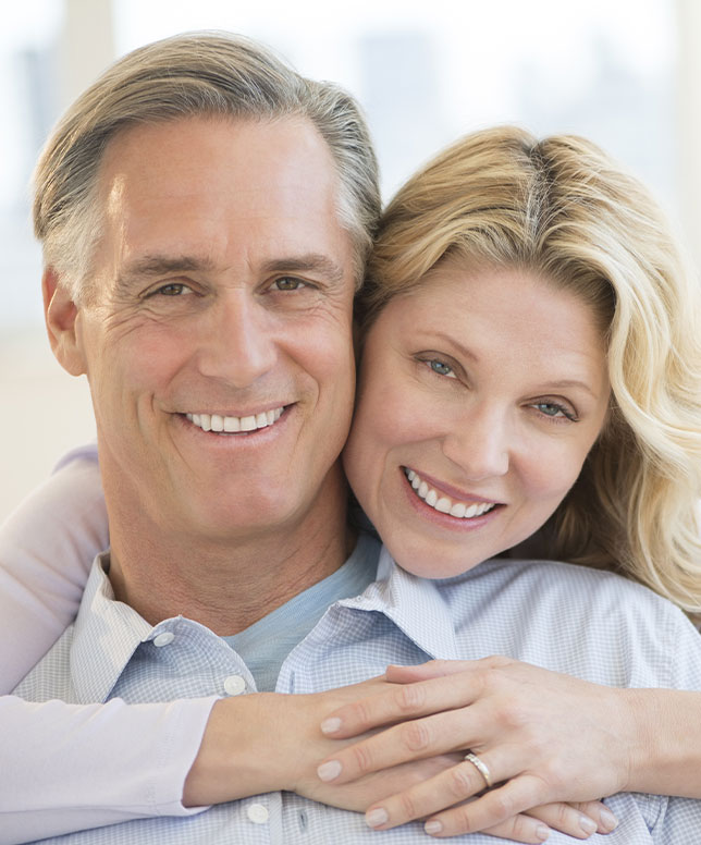 Smiling older man and woman hugging