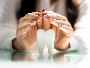 a person covering a tooth with their hands