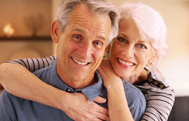 An older couple smiling and hugging