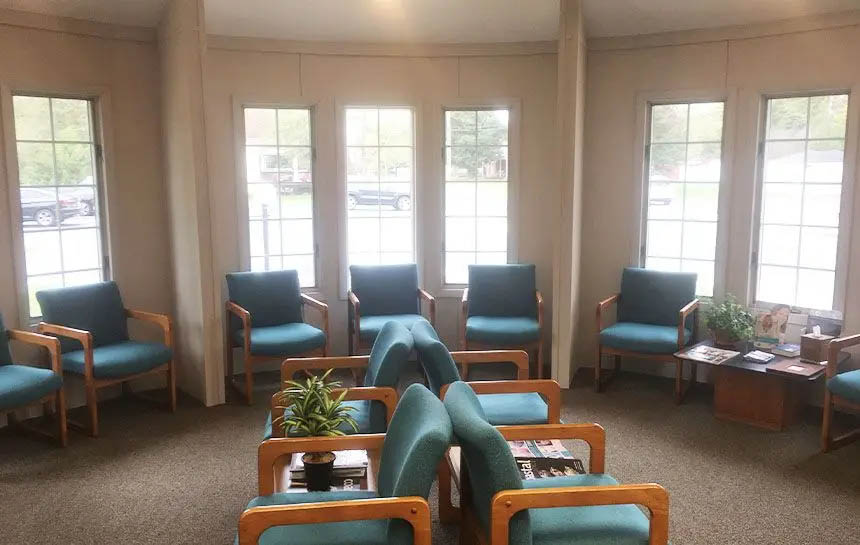 Several blue chairs in dental office waiting area