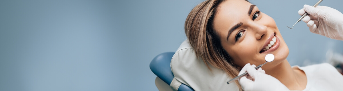 Smiling woman in dental chair before gum disease treatment in Selbyville