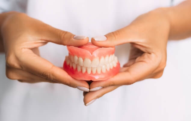 Dentist holding a set of full dentures