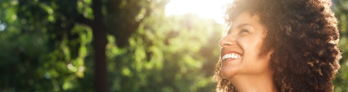 Woman grinning outdoors with tooth colored fillings in Selbyville