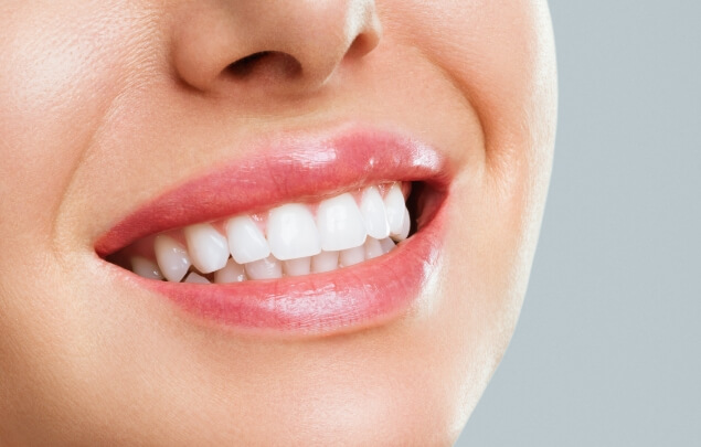 Close up of person smiling with straight white teeth