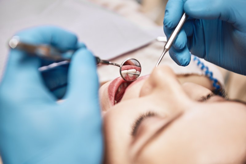 Dentist conducting dental examination on patient