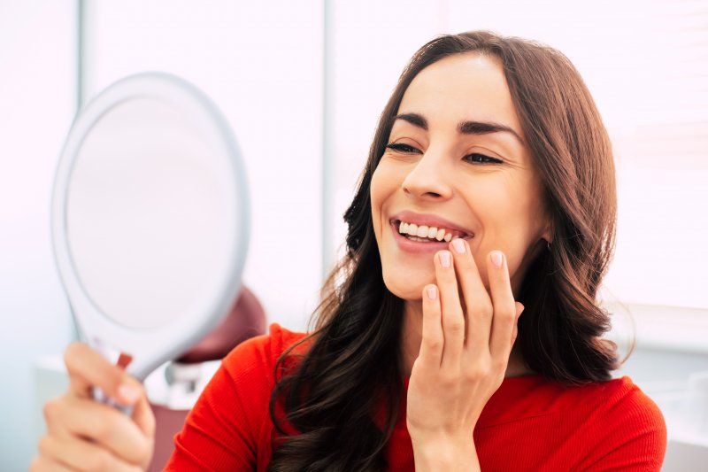 Woman smiling at reflection in the mirror