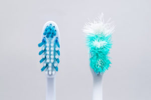 Side-by-side toothbrushes showing when to change your toothbrush