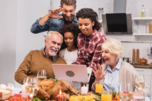 family smiling for screen at holiday gathering