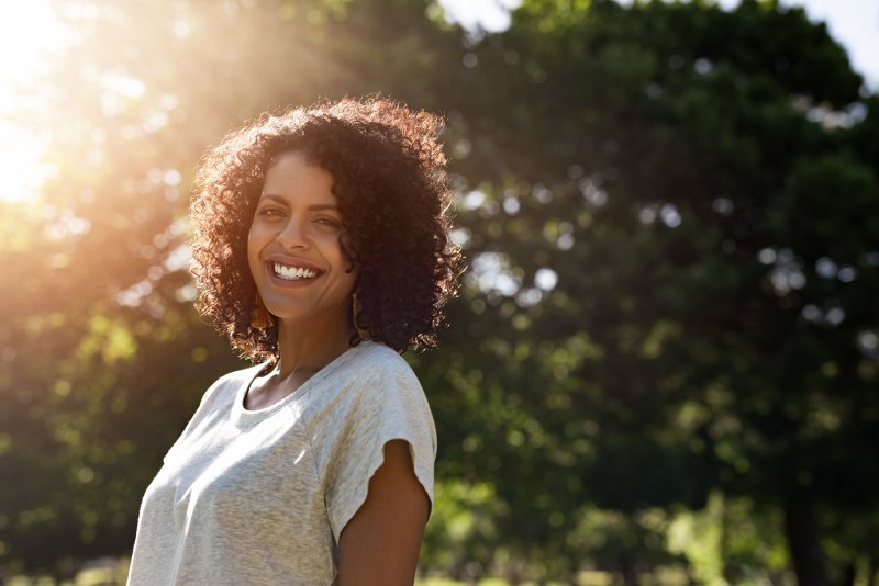 Woman smiling with a dental implant