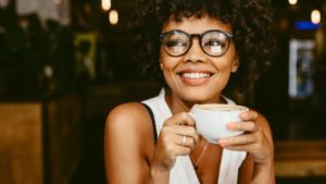 woman holding a cup of coffee on National Coffee Day 