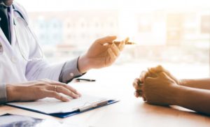 patient talking with a doctor about oral health and overall well-being