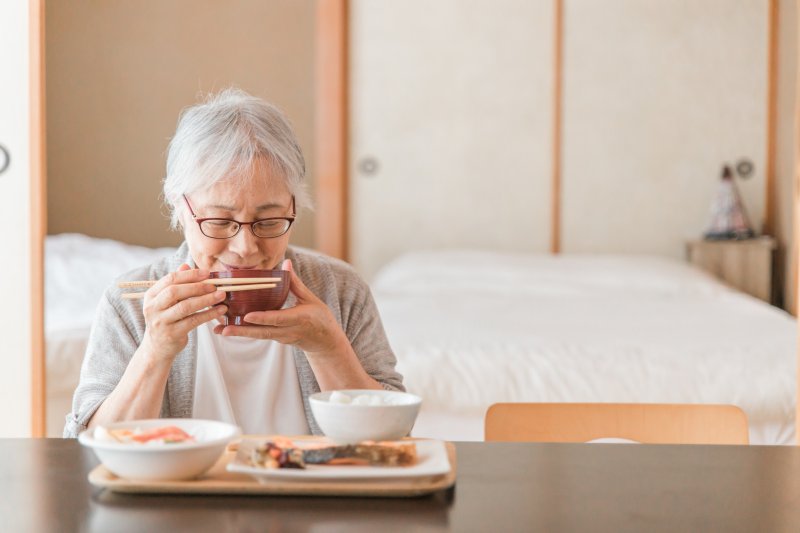 woman tasting food while wearing dentures in Selbyville