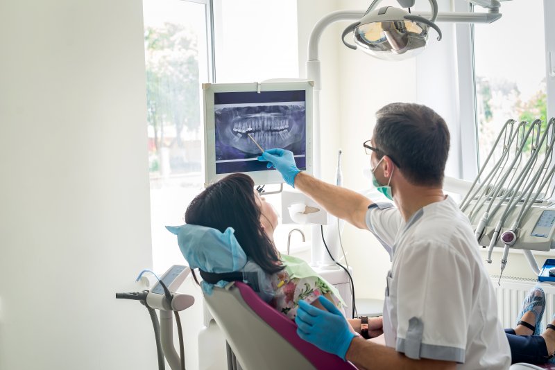 A dentist pointing to dental X-rays in Selbyville