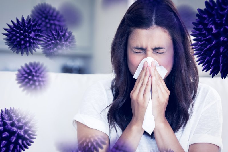 a sneezing woman surrounded by germs