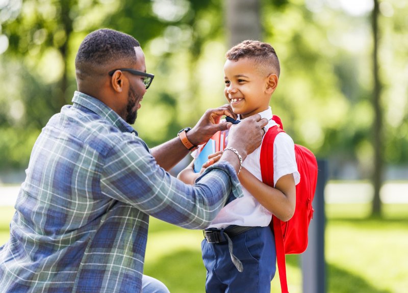 Man prepares child for school